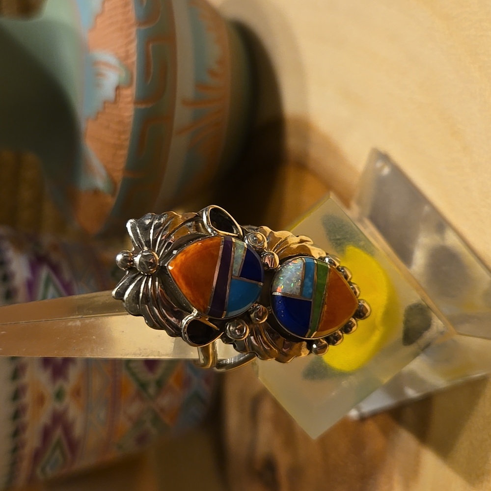 Sterling silver with multi gem stones and shell inlay.